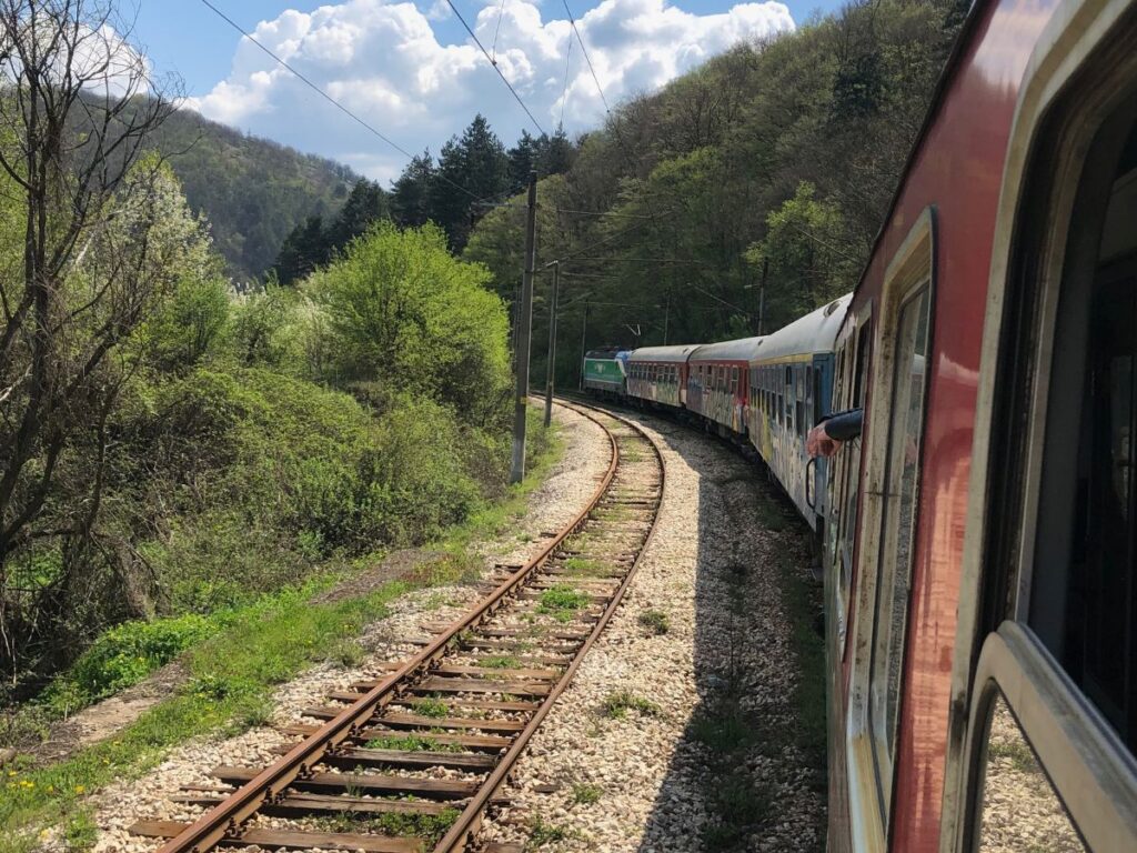 outside window of a train as it runs along the track from Sofia to Plovdiv, Bulgaria