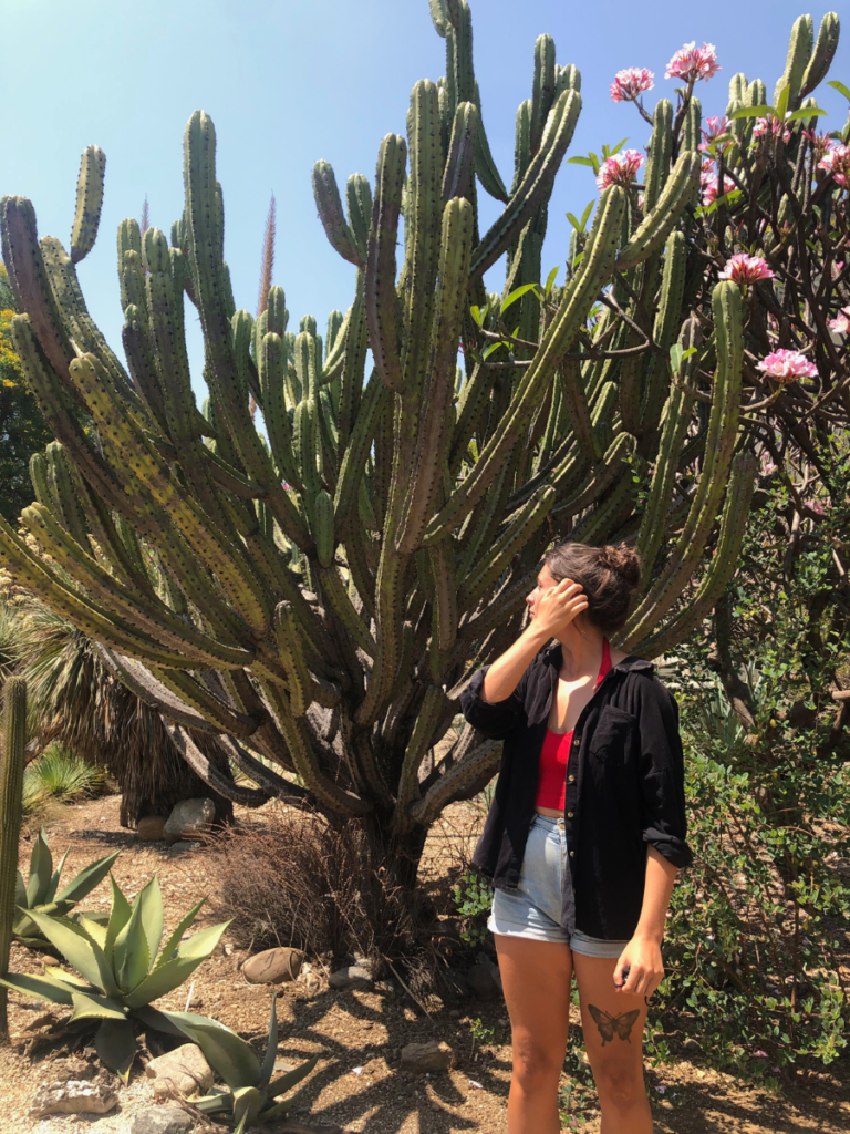 standig in front of plant at the botanical gardens in Oaxaca