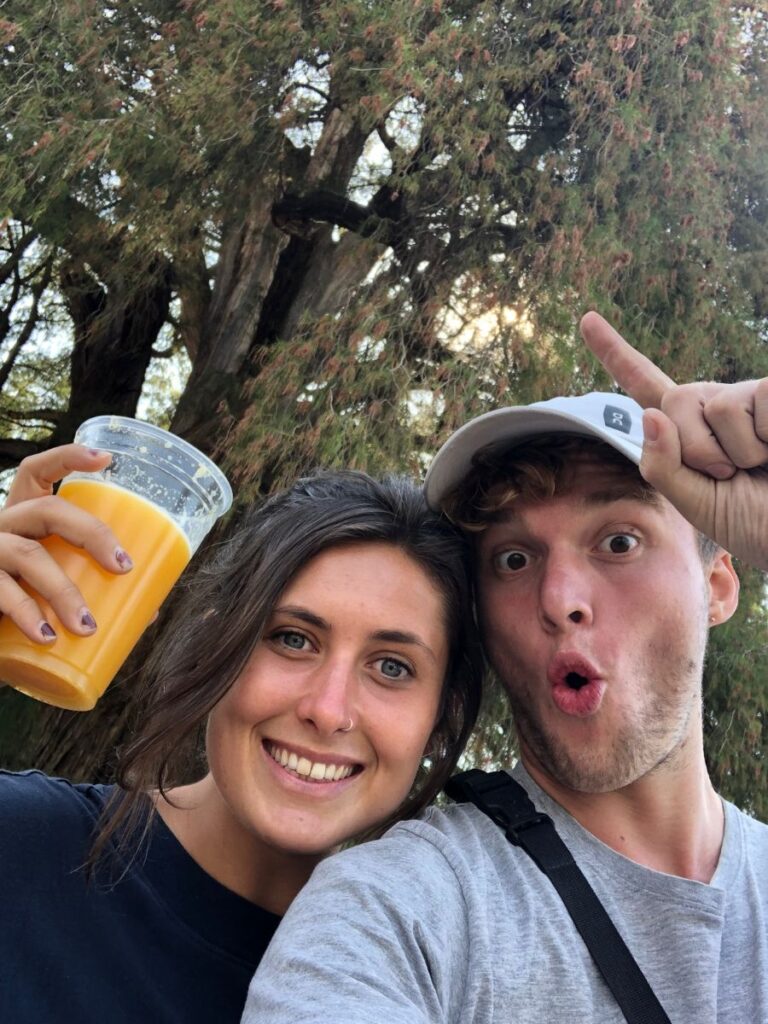 jules and marius smiling in front of el arbol de tul, the widdest tree in the world