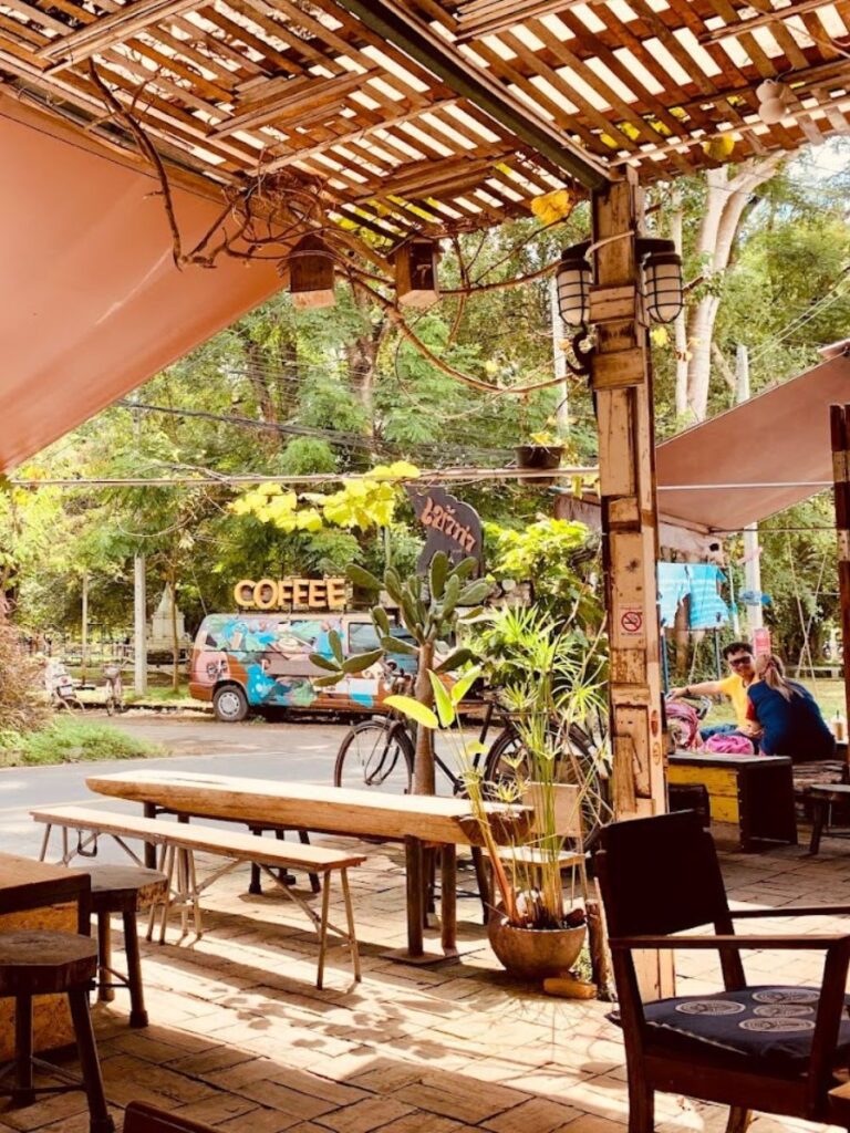 exterior khaotha coffee shop, Pai thailand, in the background a van with a big sign saying "coffee"