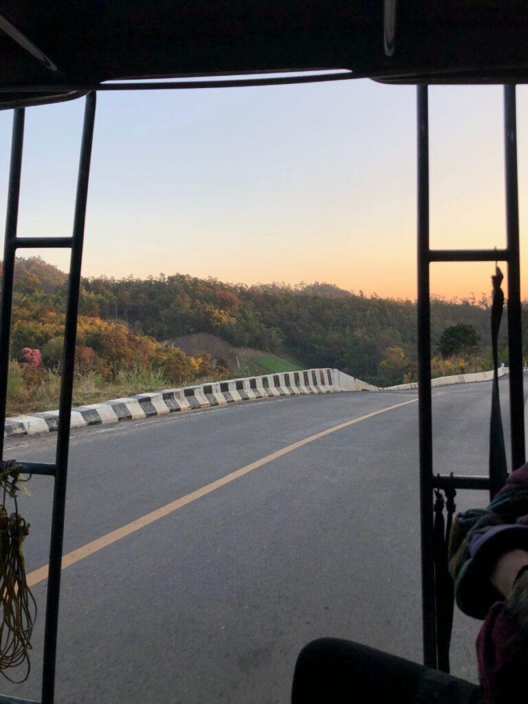 riding in a red truck out of chiang mai