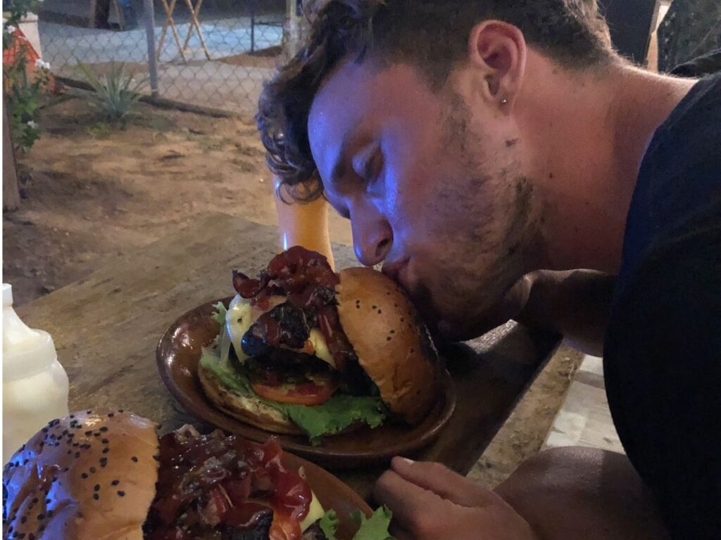 marius kissing burger from oaxaca grill because he loves it so much