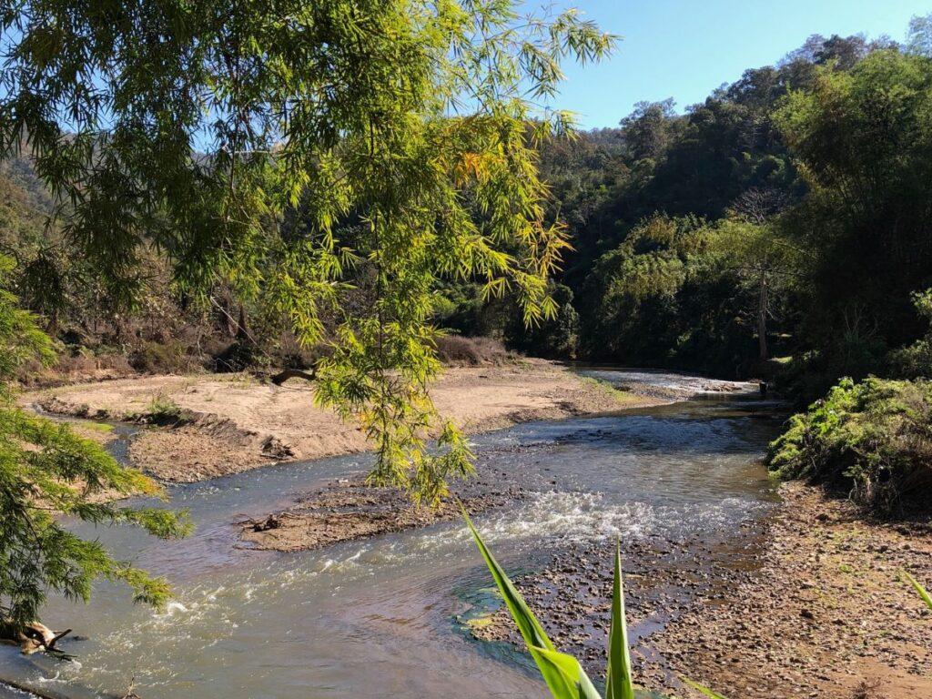 long flowing river on pai river trail hike in Pai, thailand