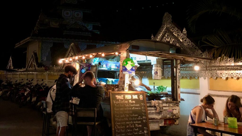 thai food truck near jazz house on walking street, pai, people sitting on tables