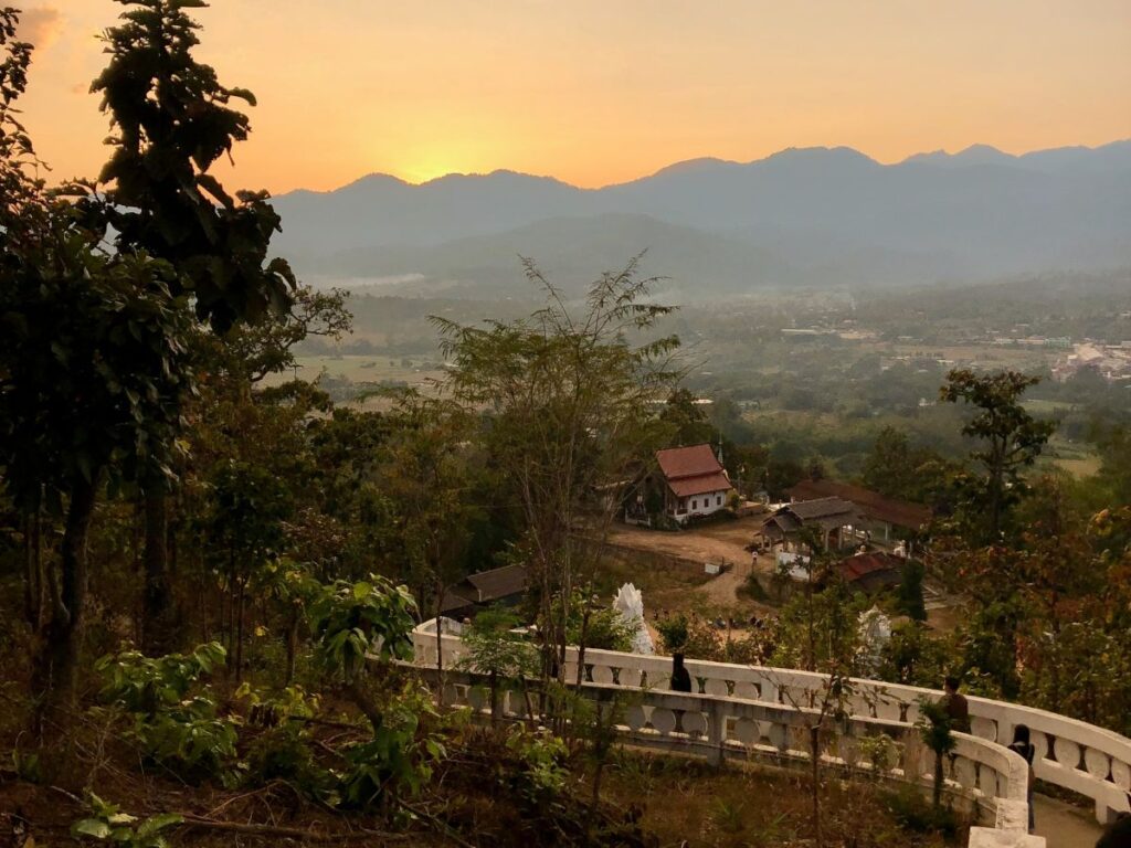 view from the top of big buddha pai, thailand, mountainscape orange and yellow sky