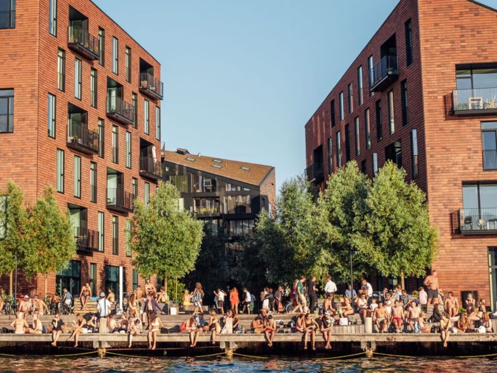 people enjoying the sun at kroyers plads in copenhagen at summertime