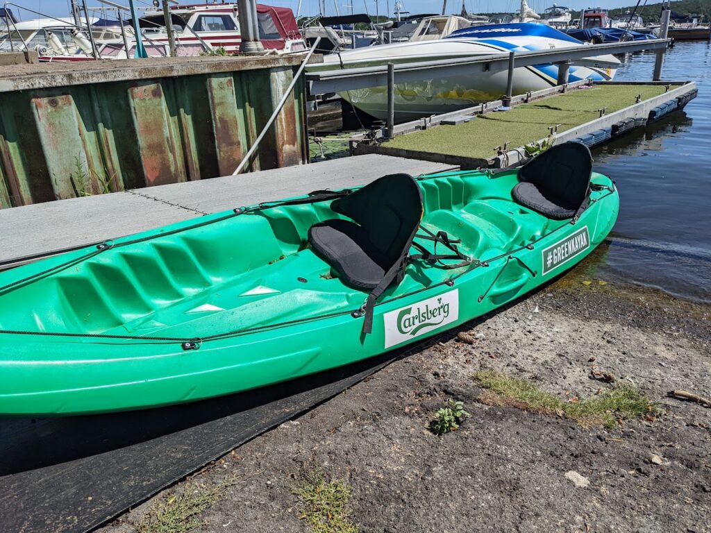 up-close of a green kayak sponsered by carlsberg