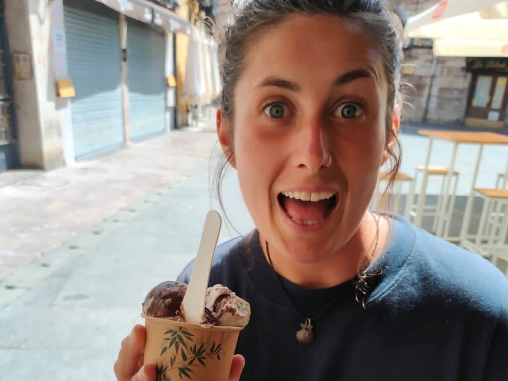 girl holding icecream smiling in Lyon, Spain, on the camino de frances