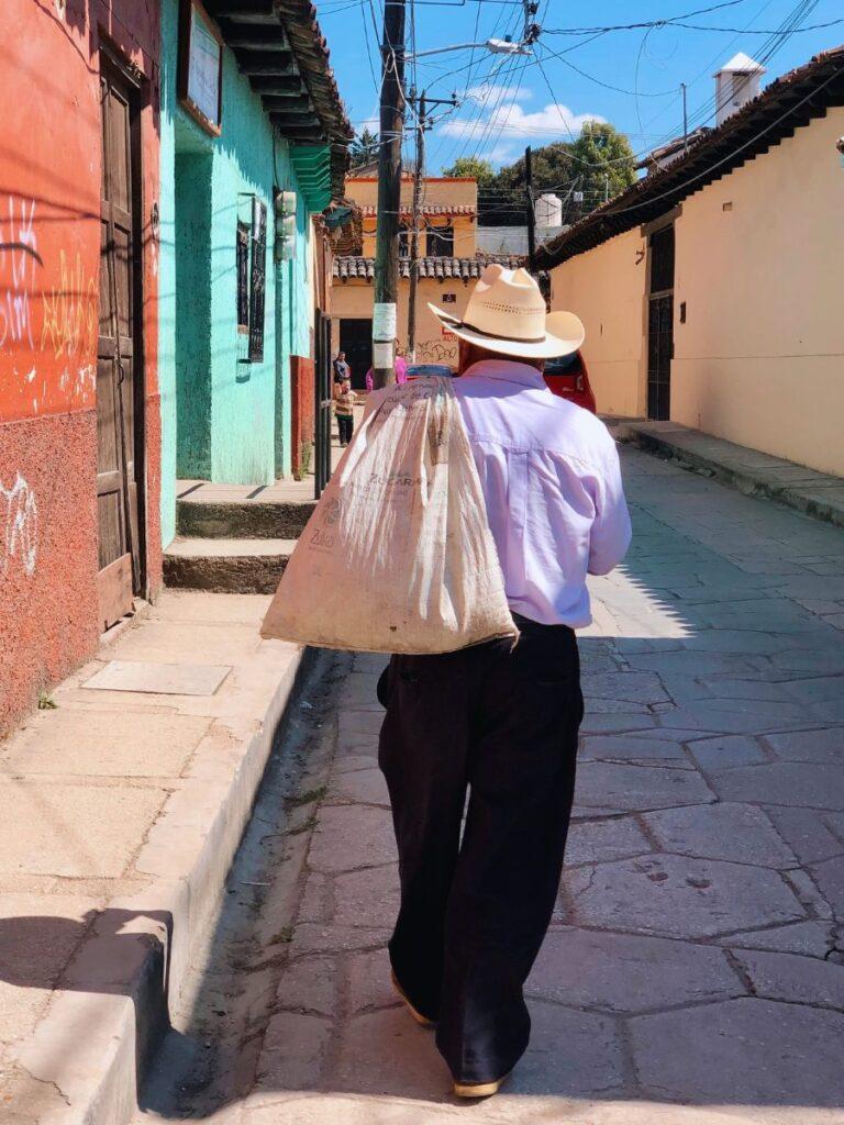 cowboy walking through streets in san cristobal de lasas