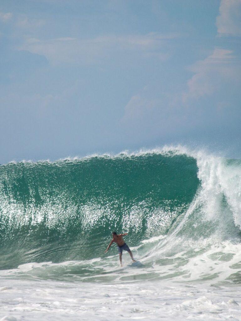 surfer surfing the dangerous waves in puerto escondido