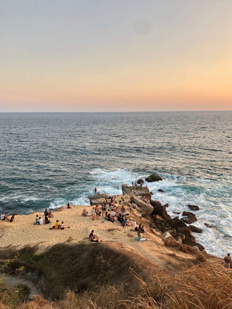 group of people watching the sunset in puerto escondido