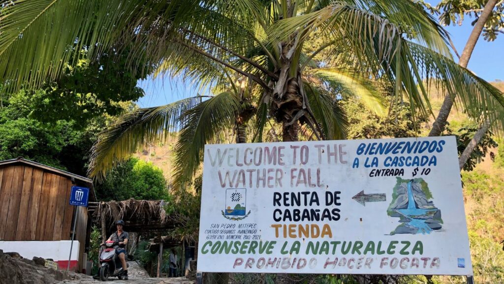 entrance sign to la reforma waterfall near puerto escondido