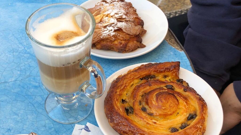 table with pastries and coffee on at Oh lala! a cafe on Real de Guadalupe Street San Cristobal