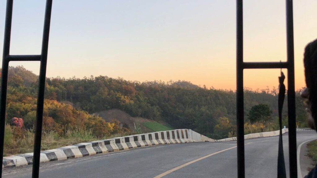 view from the back of an open red truck carrying people to Wat Pa Tam Forest Monastery Pai to Chiang Mai, Northern Thailand