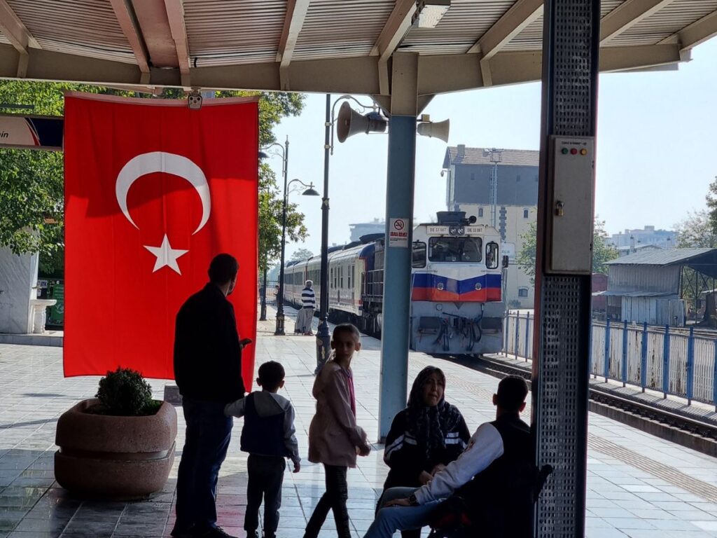 Eastern Turkey Guney kurtalan express train coming into Diyarbakir station, passengers waiting