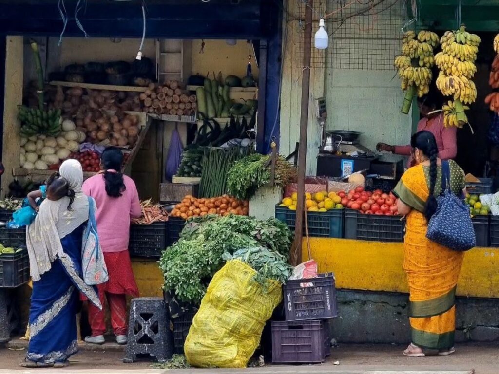 three women gathered at fruit stall on bedford high street, upper cooonoor