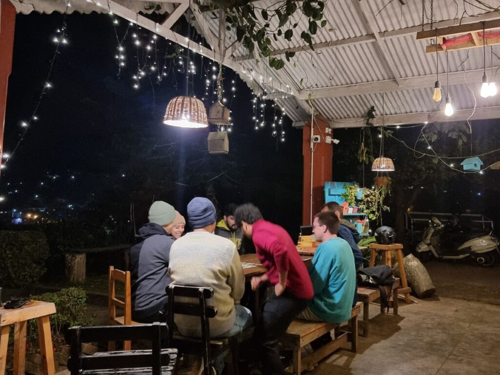 group of travellers playing boardgames in the Birdhouse Hostel in Coonoor, India