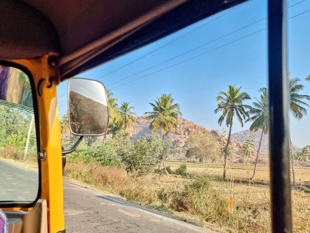 views of green fields in tuktuk from Hospete Train Station to Hanumanahalli, North Hampi