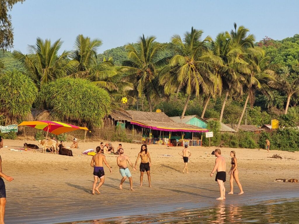 six travellers playing ball at the end of Om Beach, Gokarna