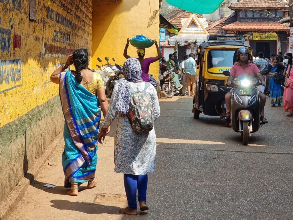 Women walking carrying packages on their head in Gokarna town