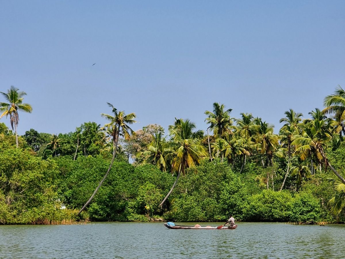 Two fishermen on a boat near Golden Island Ponnumthuruth, Kerala