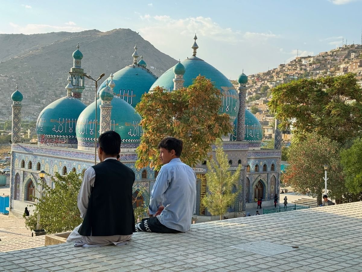Two boys sit on steps at Sakhi Shrine, Kabul