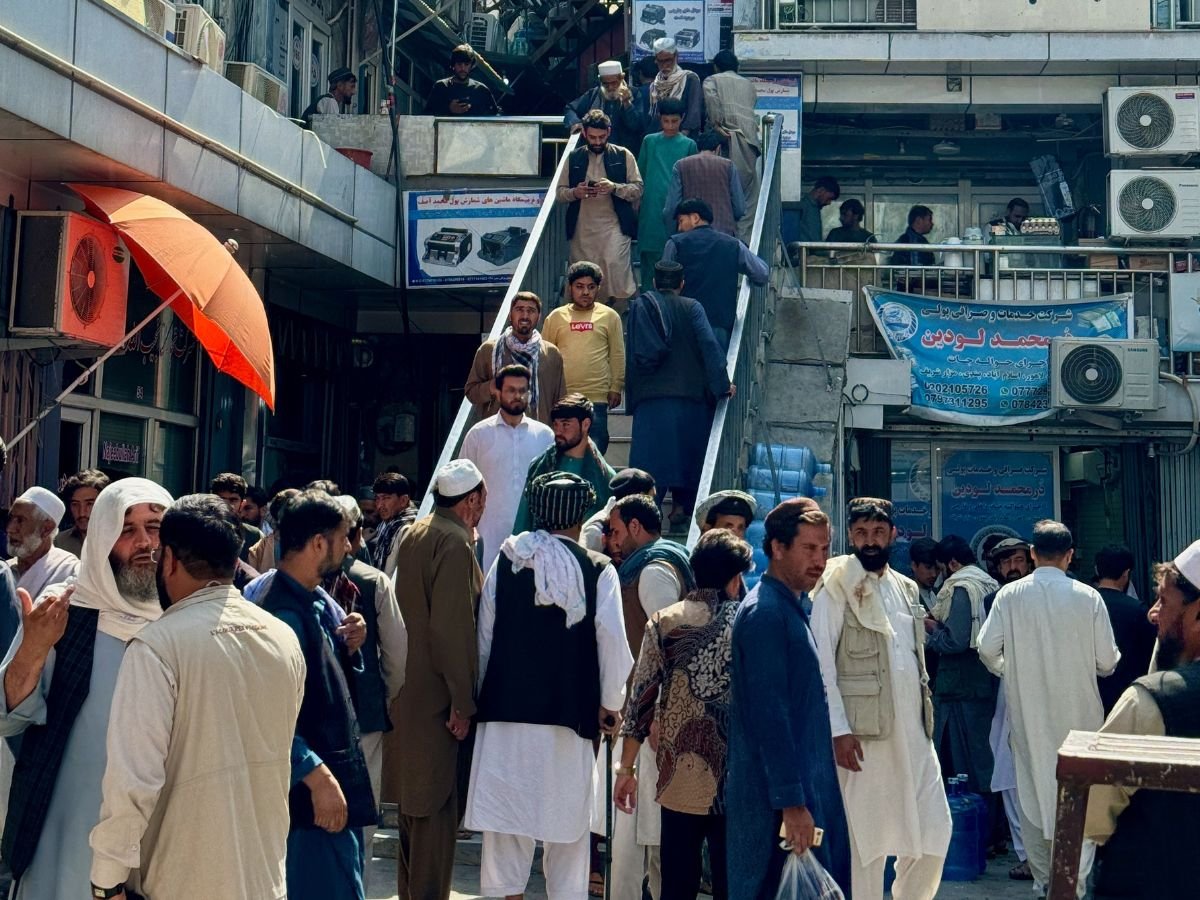 Men gathering inside exchange market in Kabul