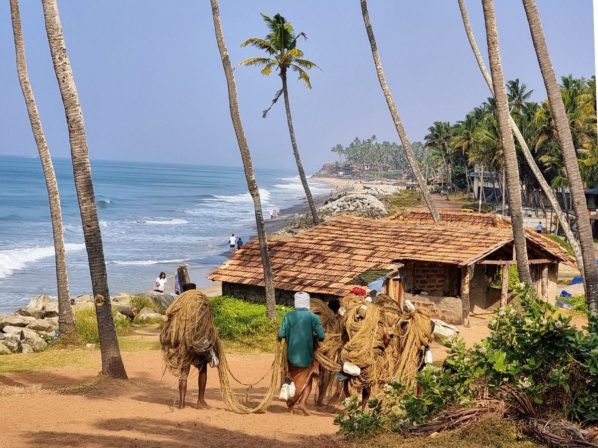 Fishermen carrying fishing nets in Varkala, India
