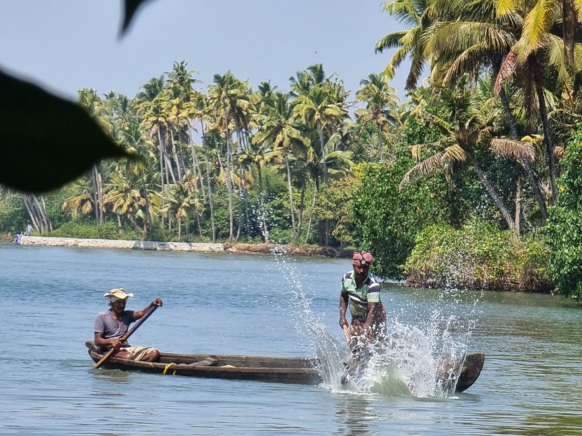 Two fishermen on fishing boat on Munroe Island, Kerala