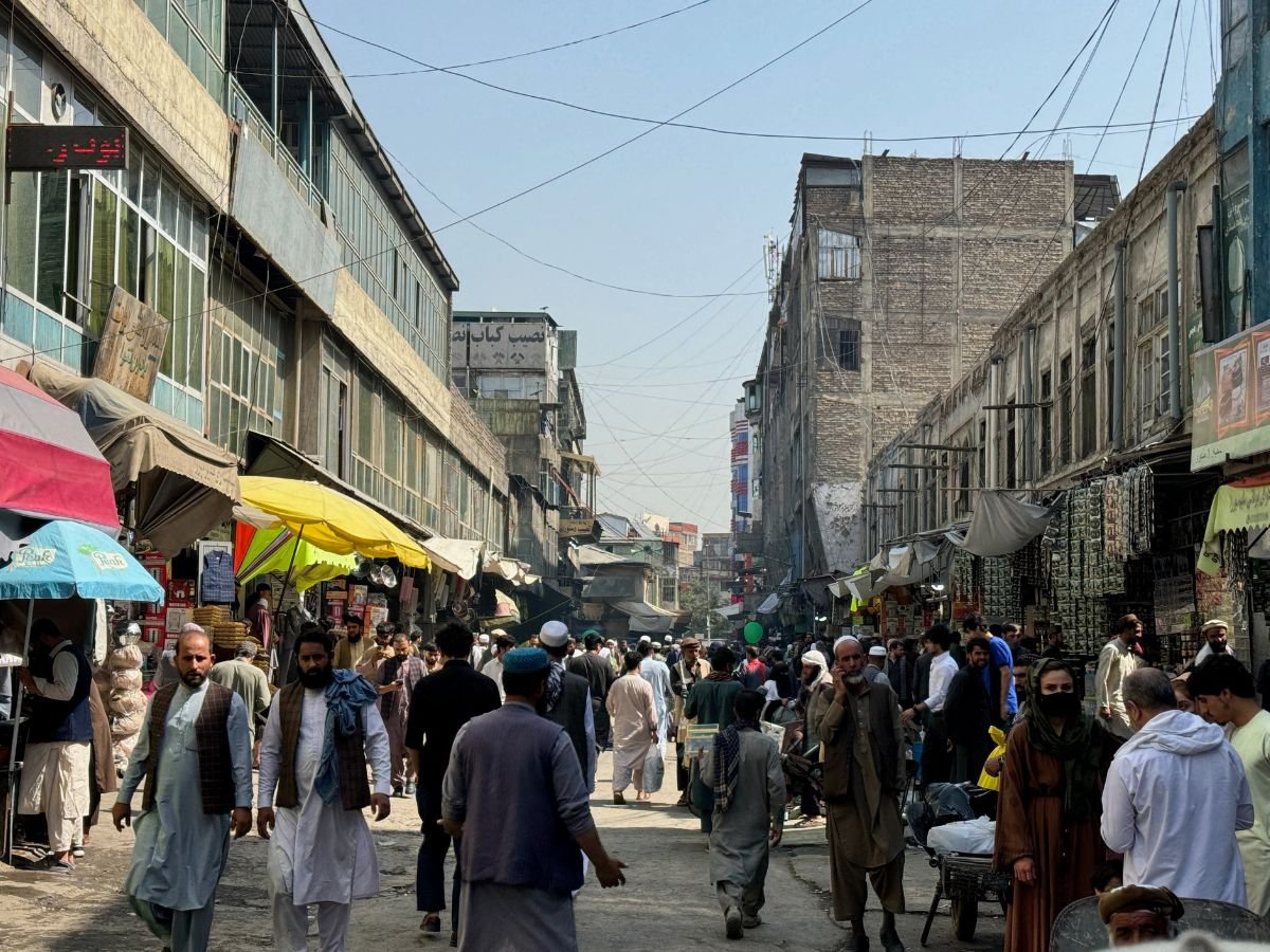 Hundreds of men walking down the central shopping street in Kabul