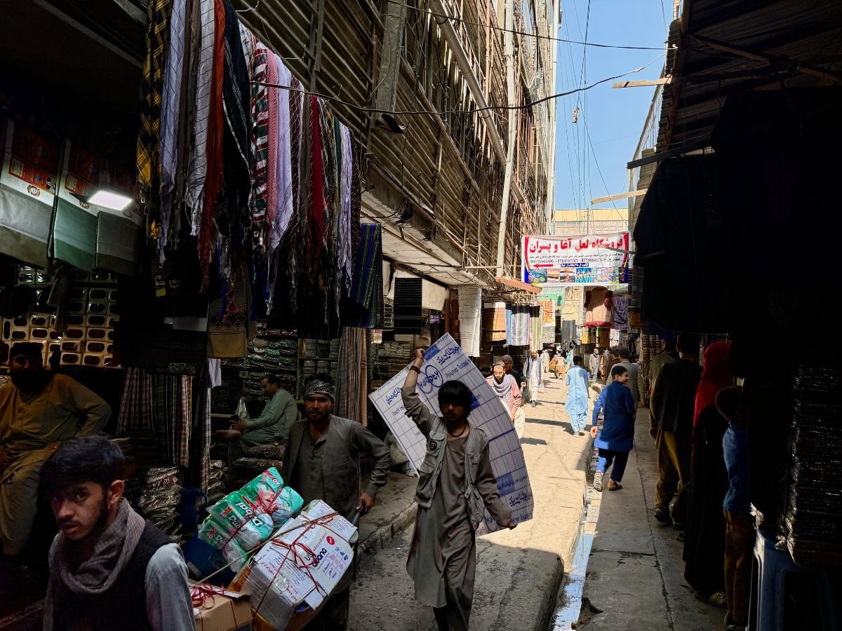 Boy carrying picture down street of Kabul, Afghanistan