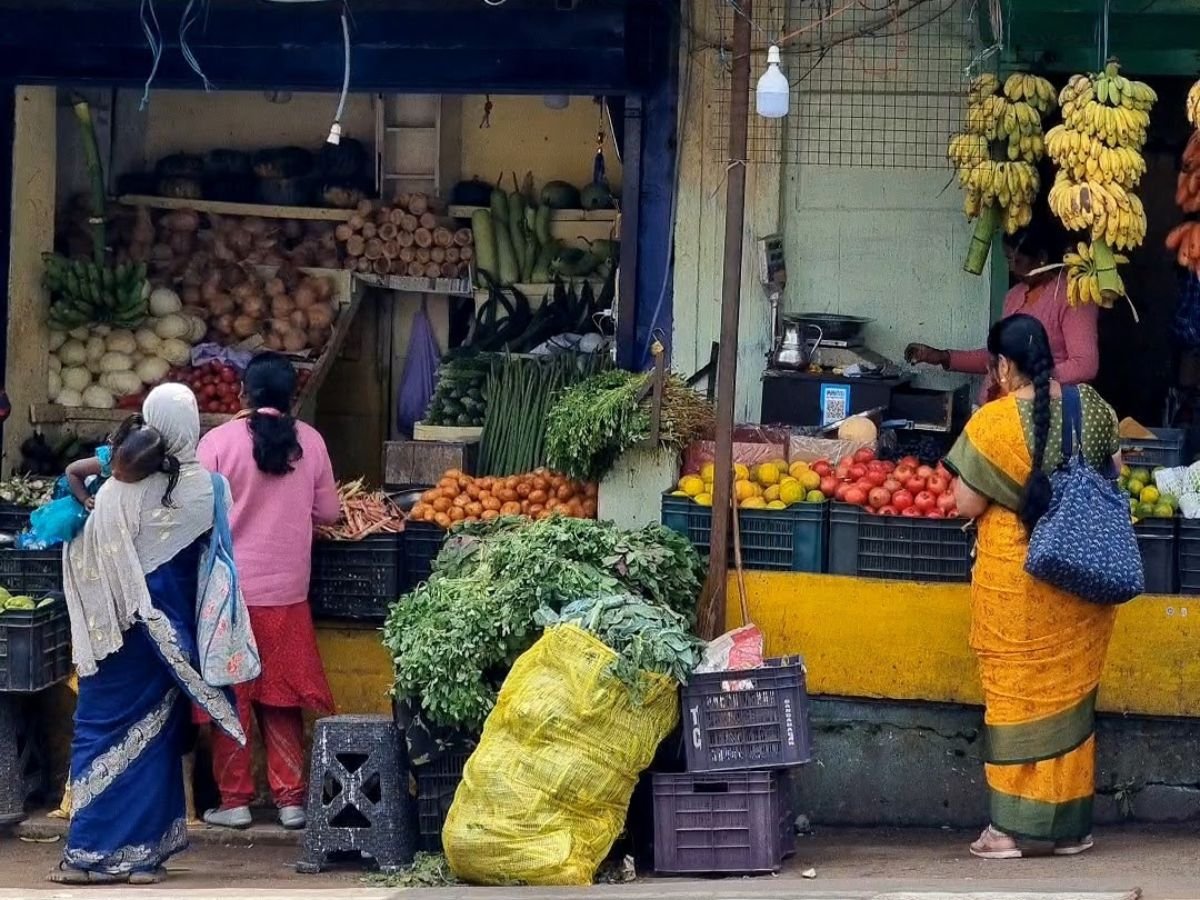 Women buying fruit on Bedford High Street, Coonoor